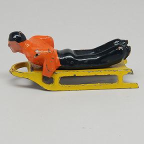 Barclay Man lying on Sled Lead Dimestore Figure